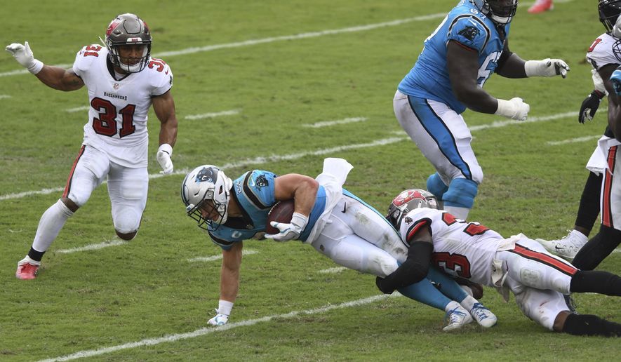 Carolina Panthers running back Christian McCaffrey (22) gets tripped up by Tampa Bay Buccaneers free safety Jordan Whitehead (33) during the second half of an NFL football game Sunday, Sept. 20, 2020, in Tampa, Fla. (AP Photo/Jason Behnken)  **FILE**