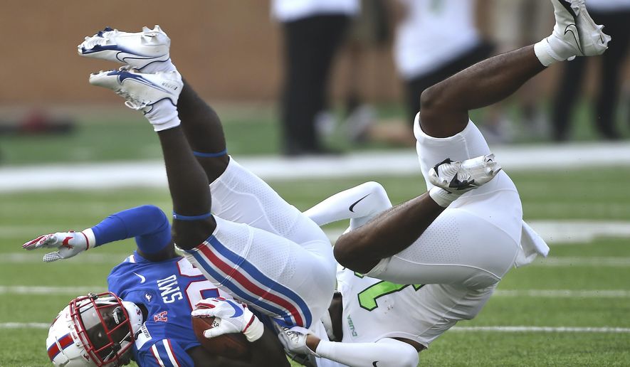North Texas safety Makyle Sanders (10) puts SMU's running back Ulysses Bentley IV, left, on his head with a strong tackle during an NCAA college football game Saturday, Sept. 19, 2020, in Denton, Texas. (Al Key/The Denton Record-Chronicle via AP)