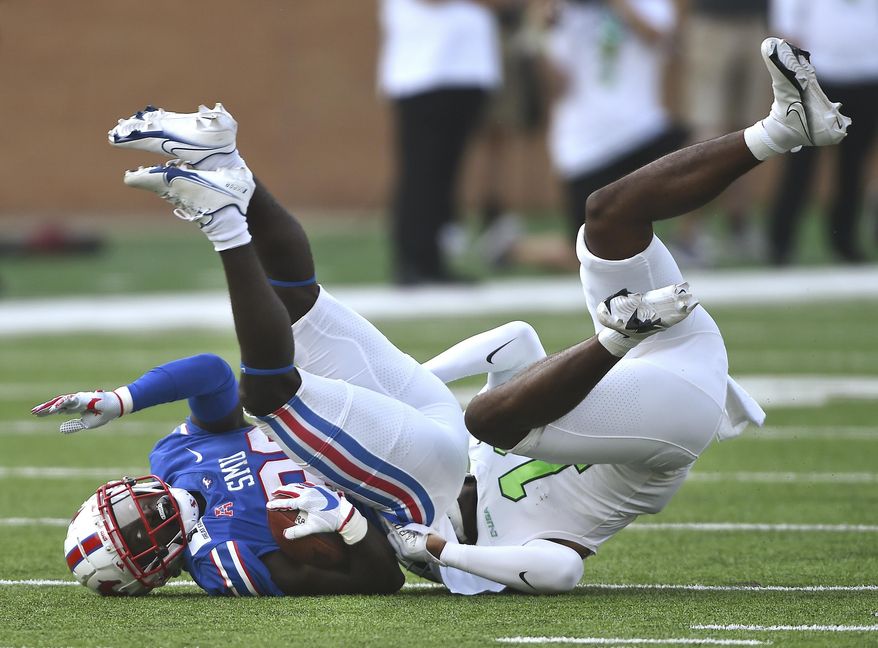 North Texas safety Makyle Sanders (10) puts SMU's running back Ulysses Bentley IV, left, on his head with a strong tackle during an NCAA college football game Saturday, Sept. 19, 2020, in Denton, Texas. (Al Key/The Denton Record-Chronicle via AP)