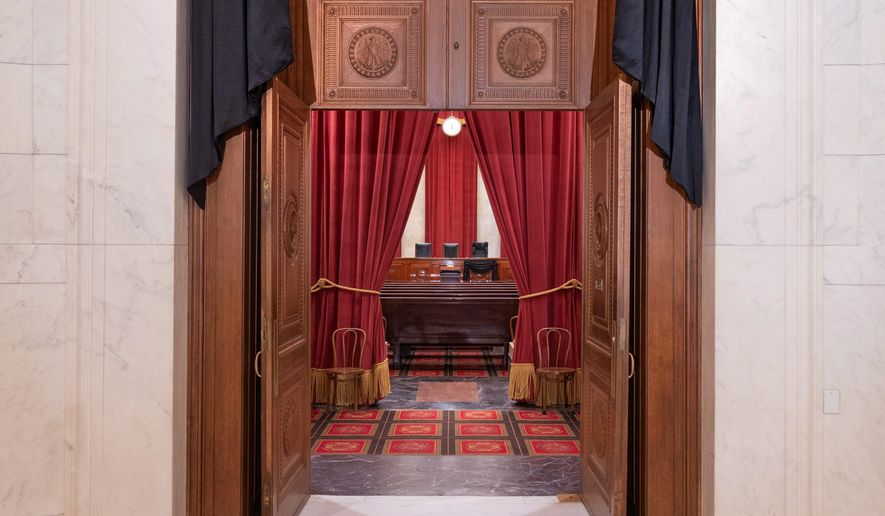 The entrance to the Supreme Court building&#39;s courtroom is seen through in this Sept. 19, 2020, file photo. (Associated Press)  **FILE**