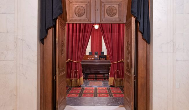 The entrance to the Supreme Court building&#x27;s courtroom is seen through in this Sept. 19, 2020, file photo. (Associated Press)  **FILE**