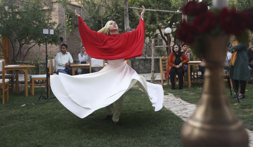 Fahima Mirzaie performs a Sema dance (Sufi Whirling) in Kabul Afghanistan, Thursday, Aug. 20, 2020. Taking on an unorthodox task in her society, the 24-year-old teaches men and women Sufi whirling. Mirzaie spins alongside men at an Afghan Italian restaurant in center of the capital, Kabul. (AP Photo/Mariam Zuhaib)
