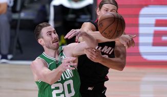 Boston Celtics&#39; Gordon Hayward (20) and Miami Heat&#39;s Kelly Olynyk, right, compete for control of a rebound during the first half of an NBA conference final playoff basketball game, Saturday, Sept. 19, 2020, in Lake Buena Vista, Fla. (AP Photo/Mark J. Terrill)