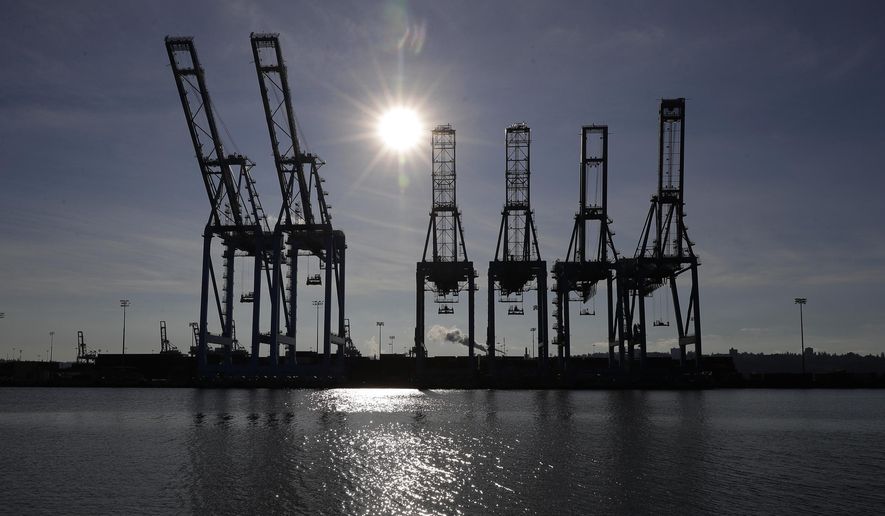 FILE - This Nov. 4, 2019, file photo shows cargo cranes at the Port of Tacoma in Tacoma, Wash. U.S lawmakers are pushing for a ban on exports from an area of northwest China following a report that found widespread use of forced labor. (AP Photo/Ted S. Warren, File)