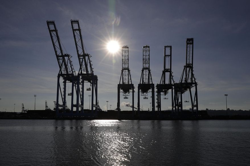 FILE - This Nov. 4, 2019, file photo shows cargo cranes at the Port of Tacoma in Tacoma, Wash. U.S lawmakers are pushing for a ban on exports from an area of northwest China following a report that found widespread use of forced labor. (AP Photo/Ted S. Warren, File)