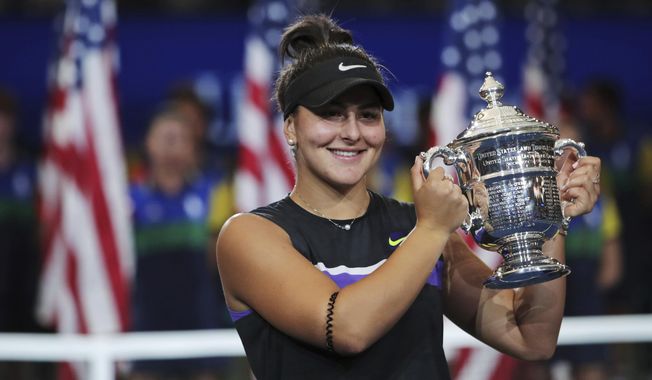 FILE - In this Saturday, Sept. 7, 2019, file photo, Bianca Andreescu, of Canada, holds up the championship trophy after defeating Serena Williams in the women&#x27;s singles final of the U.S. Open tennis championships in New York. Andreescu will sit out the French Open and the rest of 2020. The 20-year-old announced her decision to remain sidelined this season via a post on Instagram on Tuesday, Sept. 22, 2020. (AP Photo/Charles Krupa, File)
