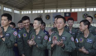 Taiwanese airmen applaud as they listen to Taiwan President Tsai Ing-wen speak during her visit to the Penghu Magong military air base in outlying Penghu Island, Taiwan Tuesday, Sept. 22, 2020. Tsai visited the military base on one of Taiwan’s outlying islands Tuesday in a display of resolve following a recent show of force by rival China. (AP Photo/Wu Huizhong)