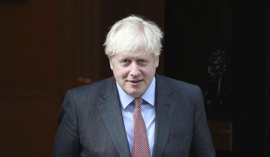 Britain's Prime Minister Boris Johnson leaves 10 Downing Street, London, Monday Sept. 21, 2020. Britain’s chief medical officers have raised the nation’s official COVID-19 alert level, meaning the virus is in general circulation and the transmission is high. Boris Johnson is expected to announce further curbs Tuesday to slow the spread of the virus. (Yui Mok/PA via AP)