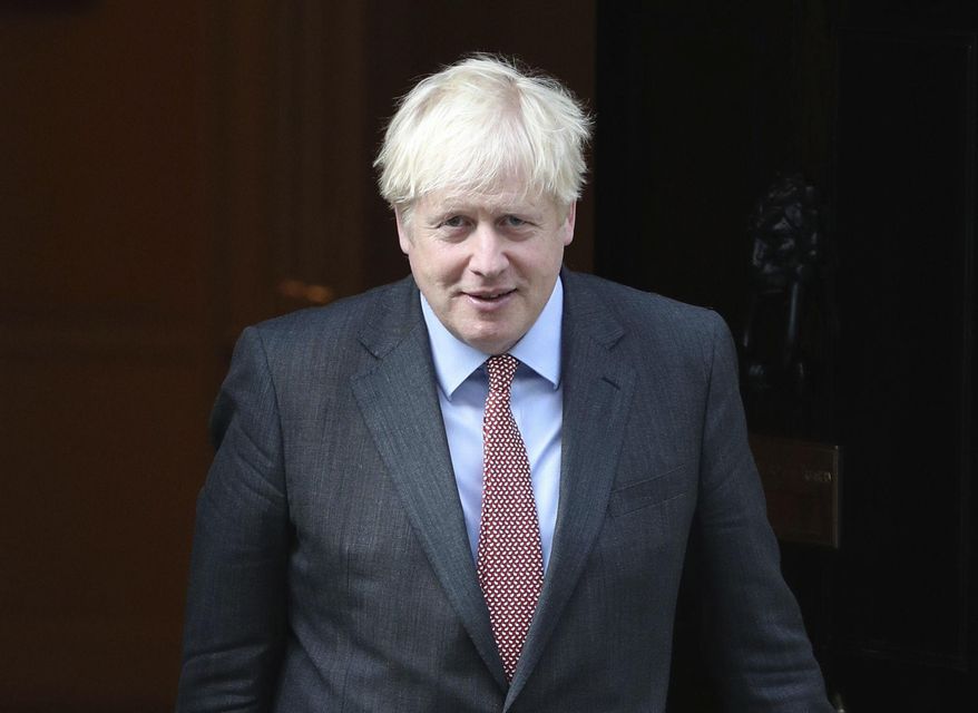 Britain's Prime Minister Boris Johnson leaves 10 Downing Street, London, Monday Sept. 21, 2020. Britain’s chief medical officers have raised the nation’s official COVID-19 alert level, meaning the virus is in general circulation and the transmission is high. Boris Johnson is expected to announce further curbs Tuesday to slow the spread of the virus. (Yui Mok/PA via AP)