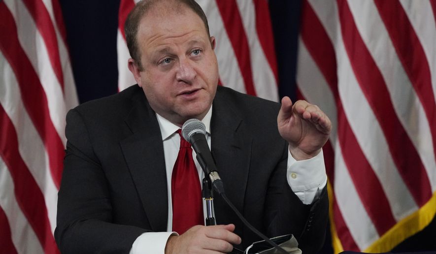 Colorado Governor Jared Polis makes a point about the increase in the state's new coronavirus cases over the past three weeks during a news conference Tuesday, Sept. 22, 2020, in Denver. (AP Photo/David Zalubowski)