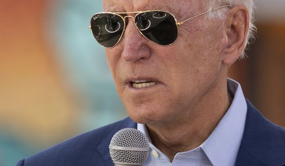 Social distancing circles are reflected int he the sunglasses of Democratic presidential candidate former Vice President Joe Biden as he speaks during a Biden for President Black economic summit at Camp North End in Charlotte, N.C., Wednesday, Sept. 23, 2020. (AP Photo/Carolyn Kaster)