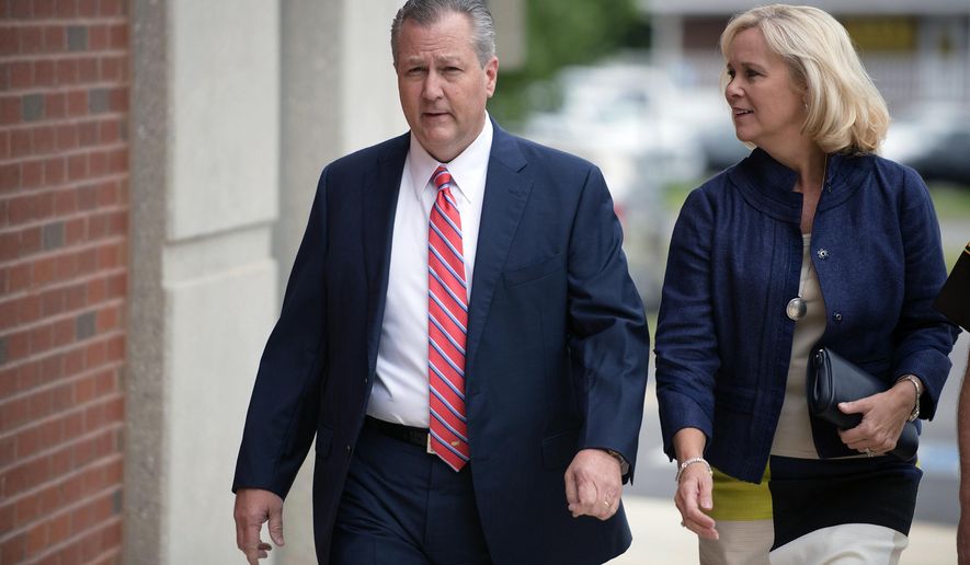 FILE - In this Friday, Sept. 2, 2016 file photo, Mike Hubbard, former Alabama Speaker of the House, and his wife, Susan, arrive for a post trial hearing at the Lee County Justice Center in Opelika, Ala..  Mike Hubbard reported Friday, Sept. 11, 2020 to a county detention center to begin the sentence after an  unsuccessful effort to overturn his conviction. (Albert Cesare/The Montgomery Advertiser via AP, Pool)