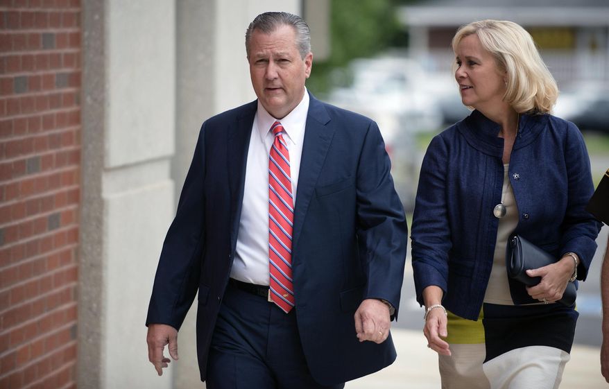 FILE - In this Friday, Sept. 2, 2016 file photo, Mike Hubbard, former Alabama Speaker of the House, and his wife, Susan, arrive for a post trial hearing at the Lee County Justice Center in Opelika, Ala..  Mike Hubbard reported Friday, Sept. 11, 2020 to a county detention center to begin the sentence after an  unsuccessful effort to overturn his conviction. (Albert Cesare/The Montgomery Advertiser via AP, Pool)