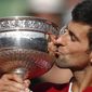 FILE - In this June 5, 2016, file photo, Serbia&#39;s Novak Djokovic kisses the trophy after winning the final of the French Open tennis tournament against Britain&#39;s Andy Murray in four sets 3-6, 6-1, 6-2, 6-4, at Roland Garros stadium in Paris. Djokovic traveled to the United States, won the Western &amp;amp; Southern Open and experienced a tumultuous exit from the 2020 U.S. Open via disqualification, then flew back halfway around the world and won the Italian Open, which he probably considers perfect preparation for the year’s last Grand Slam tournament, the French Open. (AP Photo/Christophe Ena, File)