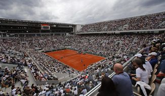 FILE - In this Sunday, June 9, 2019, file photo, Austria&#39;s Dominic Thiem, near side, plays a shot against Spain&#39;s Rafael Nadal during the men&#39;s final match of the French Open tennis tournament on the center court at Roland Garros stadium in Paris. (AP Photo/Christophe Ena, File)