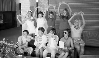 In this Sept. 23, 1970, photo provided the Houston Library, tennis players hold up $1 bills after signing a contract with World Tennis magazine publisher Gladys Heldman to turn pro and start the Virginia Slims tennis circuit. From left standing are: Valerie Ziegenfuss, Billie Jean King, Nancy Richey and Peaches Bartkowicz. From left seated are: Judy Tegart Dalton, Kerry Melville Reid, Rosie Casals, Gladys Heldman and Kristy Pigeon. Gladys Heldman replaced her daughter, Julie Heldman, who was injured and unable to pose for the 1970 photo.  It’s the 50th anniversary of Billie Jean King and eight other women breaking away from the tennis establishment in 1970 and signing a $1 contract to form the Virginia Slims circuit. That led to the WTA Tour, which offers millions in prize money. (Bela Ugrin/Courtesy Houston Library via AP)
