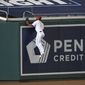 Washington Nationals center fielder Michael A. Taylor climbs the wall in vain on a home run by Philadelphia Phillies&#39; Bryce Harper during the sixth inning of a baseball game Wednesday, Sept. 23, 2020, in Washington. (AP Photo/Nick Wass)