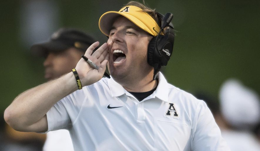 FILE - In this Sept. 28, 2019, file photo, then-Appalachian State head coach Eli Drinkwitz shouts in the second quarter of an NCAA football game against Coastal Carolina, in Boone, N.C. The debut season for Missouri coach Eli Drinkwitz got much more challenging when the Southeastern Conference adjusted its schedules this summer. Missouri’s original cross-division opponents in its SEC schedule were Arkansas and Mississippi State, which both finished below .500 last season. But when the SEC switched to a format in which each team will play 10 conference games, Missouri discovered it also would be hosting Alabama and visiting defending national champion LSU.(Allison Lee Isley/The Winston-Salem Journal via AP, File)