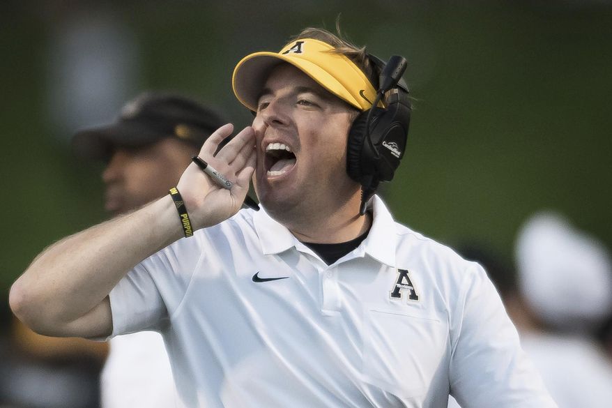 FILE - In this Sept. 28, 2019, file photo, then-Appalachian State head coach Eli Drinkwitz shouts in the second quarter of an NCAA football game against Coastal Carolina, in Boone, N.C. The debut season for Missouri coach Eli Drinkwitz got much more challenging when the Southeastern Conference adjusted its schedules this summer. Missouri’s original cross-division opponents in its SEC schedule were Arkansas and Mississippi State, which both finished below .500 last season. But when the SEC switched to a format in which each team will play 10 conference games, Missouri discovered it also would be hosting Alabama and visiting defending national champion LSU.(Allison Lee Isley/The Winston-Salem Journal via AP, File)