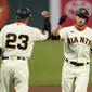San Francisco Giants&#39; Austin Slater, right, celebrates with third base coach Ron Wotus after hitting a solo home run against the Colorado Rockies during the first inning of a baseball game in San Francisco, Tuesday, Sept. 22, 2020. (AP Photo/Jeff Chiu)