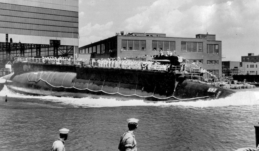FILE - In this July 9, 1960, file photo, the U.S. Navy nuclear powered attack submarine USS Thresher is launched bow-first at the Portsmouth Navy Yard in Kittery, Maine. The Navy is releasing documents from the investigation into the deadliest submarine disaster in U.S. history. A judge ordered the release of the documents that pertain to the sinking of the USS Thresher 57 years ago, and the first batch was made public on Wednesday, Sept. 23, 2020. (AP Photo, File)