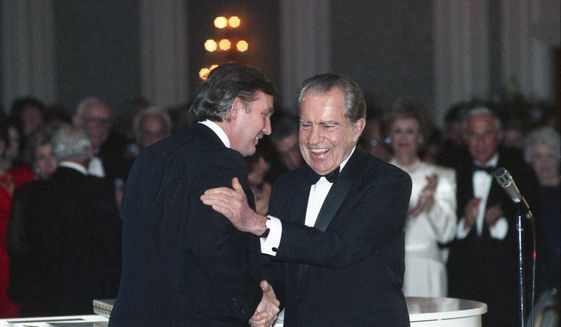 In this March 11, 1989, photo Donald Trump shakes hands with former President Richard Nixon at a tribute gala to Nellie Connally at the Westin Galleria ballroom in Houston, Texas. The letters between Trump and Nixon revealed for the first time in an exhibit that opens Thursday, Sept. 24, 2020, at the Richard Nixon Presidential Library &amp;amp; Museum, show the two men engaged in something of an exercise in mutual affirmation. The museum shared the letters exclusively with The Associated Press ahead of the exhibit’s opening. (Richard Carson/Houston Chronicle via AP)