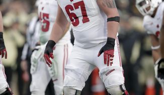 Wisconsin offensive lineman Jon Dietzen (67) during the first half of an NCAA college football game against Purdue in West Lafayette, Ind., Saturday, Nov. 17, 2018. Wisconsin has welcomed back Dietzen and lost safety Reggie Pearson as it resumes practice to prepare for the pandemic-delayed season. The Badgers released a roster Wednesday, Sept. 23, 2020 that didn’t include Pearson but added Dietzen, who had announced in February 2019 that he was stepping away from football due to injuries. (AP Photo/Michael Conroy)