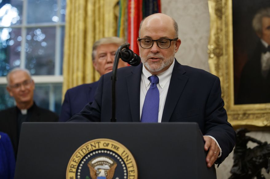 In this file photo, syndicated radio host Mark Levin speaks, with President Donald Trump behind him, during a ceremony to present the Presidential Medal of Freedom to former Attorney General Edwin Meese, in the Oval Office of the White House, Tuesday, Oct. 8, 2019, in Washington. Mr. Levin is among a number of high-profile conservatives to slam major news organizations for calling the presidential election on Nov. 7, 2020, despite ongoing vote counts and legal challenges in various states. (AP Photo/Alex Brandon) **FILE**