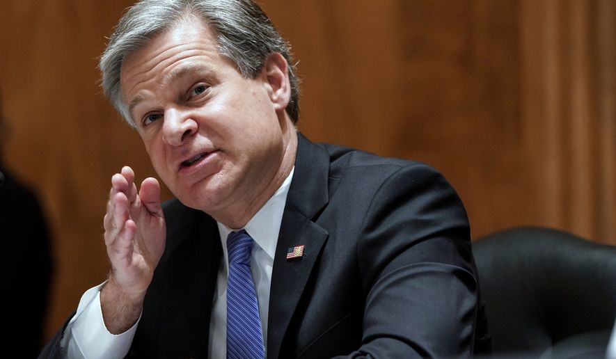 FBI Director Christopher Wray testifies at a Senate Homeland Security and Governmental Affairs Committee hearing on &quot;Threats to the Homeland&quot; Thursday, Sept. 24, 2020 on Capitol Hill in Washington. (Joshua Roberts/Pool via AP)