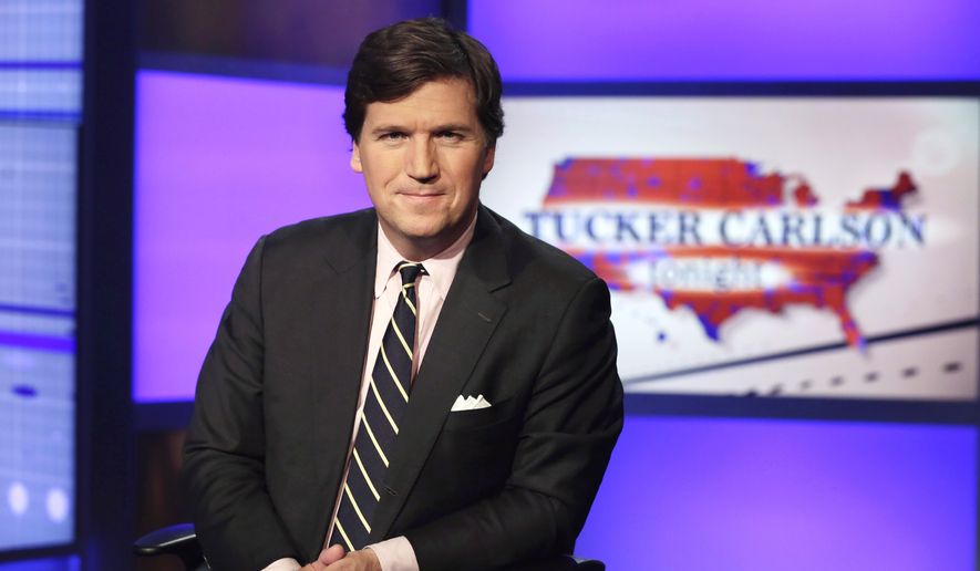 Tucker Carlson, host of &quot;Tucker Carlson Tonight,&quot; poses for photos in a Fox News Channel studio, in New York in this March 2, 2017, file photo.  A Manhattan judge has tossed out a defamation lawsuit against Fox News brought by the former Playboy model who took a $150,000 payoff to squelch her story of an affair with Donald Trump. Karen McDougal had alleged in the suit filed late last year that Fox host Tucker Carlson slandered her by calling the payout “a classic case of extortion.” The judge ruled Thursday, Sept. 24, 2020 that the remarks were “rhetorical hyperbole.&quot; (AP Photo/Richard Drew, File)