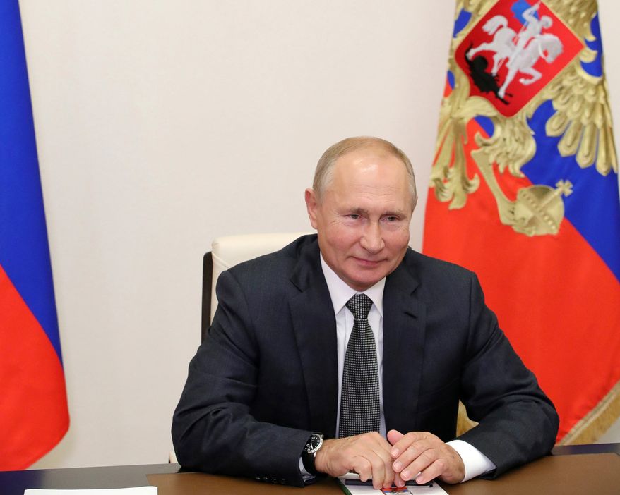Russian President Vladimir Putin gestures during a meeting with elected heads of Russian regions via video conference at the Novo-Ogaryovo residence outside Moscow, Russia, Thursday, Sept. 24, 2020. Russian health officials have reported 6,595 new coronavirus cases, the highest daily surge since July. In Moscow, more than 1,000 new cases were recorded Thursday for the first time since June. (Mikhail Klimentyev, Sputnik, Kremlin Pool Photo via AP)