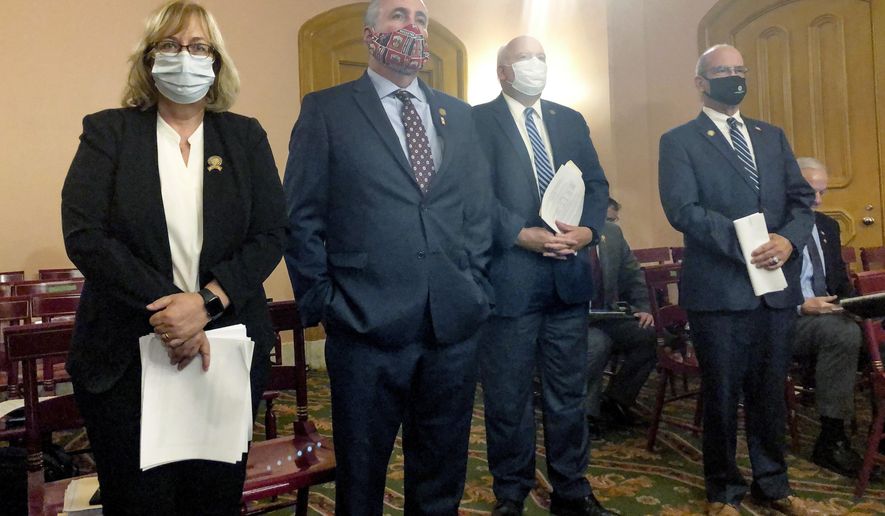 FILE – In this Sept. 10, 2020 file photo, House lawmakers, from left, Rep. Laura Lanese, R-Grove City, Rep. Dave Greenspan, R-Westlake, Rep. Michael Skindell, D-Lakewood, and Rep. Michael O'Brien, D-Warren, testify before the House Select Committee on Energy Policy and Oversight in Columbus, Ohio. Greenspan was identified Thursday, Sept. 24, 2020 to be the lawmaker who spoke with FBI agents about the passage of the legislation now tainted by a $60 million federal bribery probe. (AP Photo/Andrew Welsh-Huggins, File)