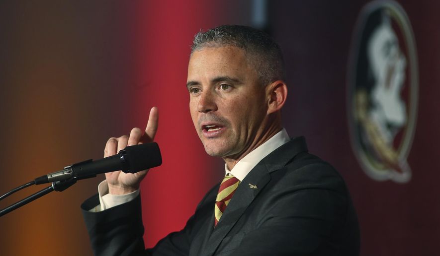 File-Florida State head football coach Mike Norvell speaks at a news conference Sunday, Dec. 8, 2019, in Tallahassee, Fla. Norvell said this week he's asymptomatic, for the coronavirus and planned to help with preparation and monitor practices remotely. Deputy head coach Chris Thomsen will fill in for him Saturday.(AP Photo/Phil Sears, File)