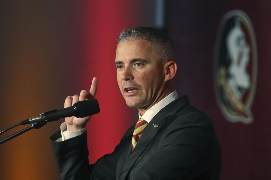 File-Florida State head football coach Mike Norvell speaks at a news conference Sunday, Dec. 8, 2019, in Tallahassee, Fla. Norvell said this week he's asymptomatic, for the coronavirus and planned to help with preparation and monitor practices remotely. Deputy head coach Chris Thomsen will fill in for him Saturday.(AP Photo/Phil Sears, File)