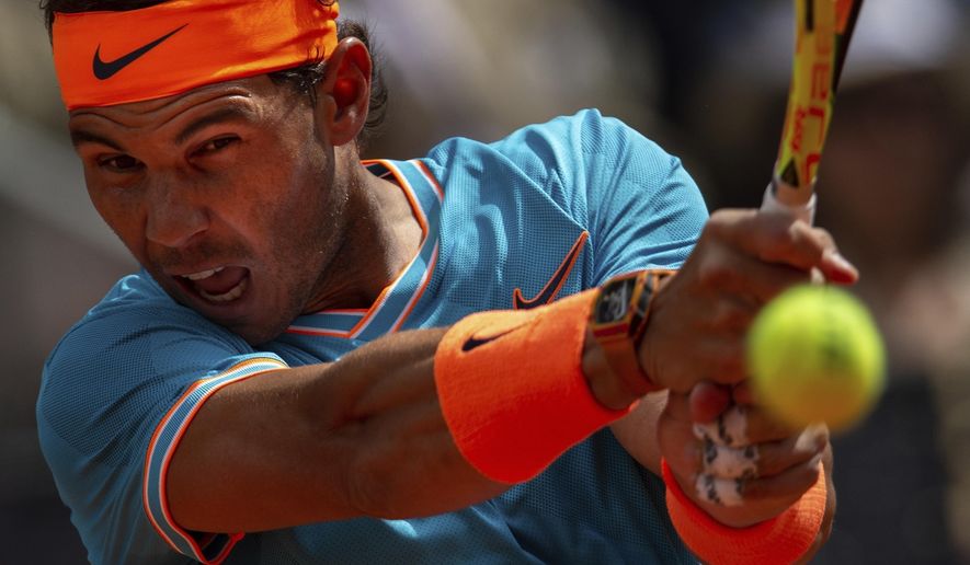 FILE - In this May 8, 2019, file photo, Rafael Nadal, from Spain, returns the ball to Felix Auger-Aliassime, from Canada, during the Madrid Open tennis tournament in Madrid. Nadal sat out the U.S. Open and has only played three matches on his favorite surface in all of 2020, hardly the sort of run-up to Roland Garros the King of Clay is used to.(AP Photo/Bernat Armangue, File)