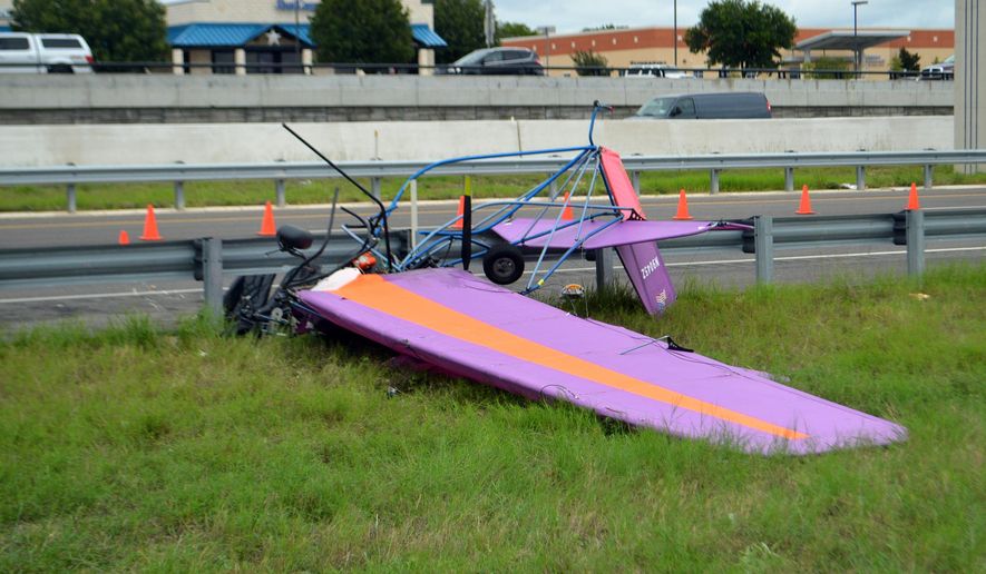 An ultralight aircraft sits mangled along Interstate 14 and the East Central Texas Expressway in front of Seton Medical Center in Harker Heights, Texas, Thursday, Sept. 24, 2020. Two people were killed in the accident, authorities said. (Thaddeus Imerman/The Killeen Daily Herald via AP)