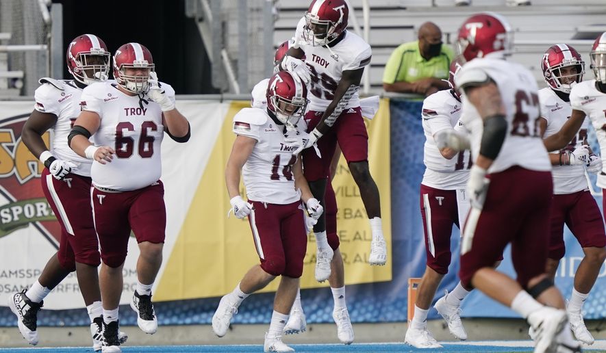 Troy wide receiver Tyler Hussey (14) is congratulated after scoring a touchdown against Middle Tennessee in the second half of an NCAA college football game Saturday, Sept. 19, 2020, in Murfreesboro, Tenn. Troy won 47-14. (AP Photo/Mark Humphrey)