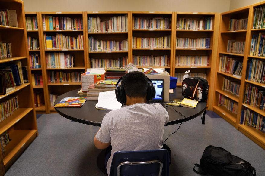 FILE - In this Aug. 26, 2020 file photo, a Los Angeles Unified School District student attends an online class at Boys & Girls Club of Hollywood in Los Angeles. A group of nine parents is filing a lawsuit Thursday, Aug. 24, 2020 alleging the Los Angeles Unified School District's distance learning program since the pandemic has failed to meet state standards or guarantee a basic education and disproportionately harms Black and Latino students. (AP Photo/Jae C. Hong, File)