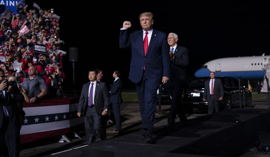 President Donald Trump arrives to speak at a campaign rally, Friday, Sept. 25, 2020, in Newport News, Va., with Vice President Mike Pence. (AP Photo/Evan Vucci)