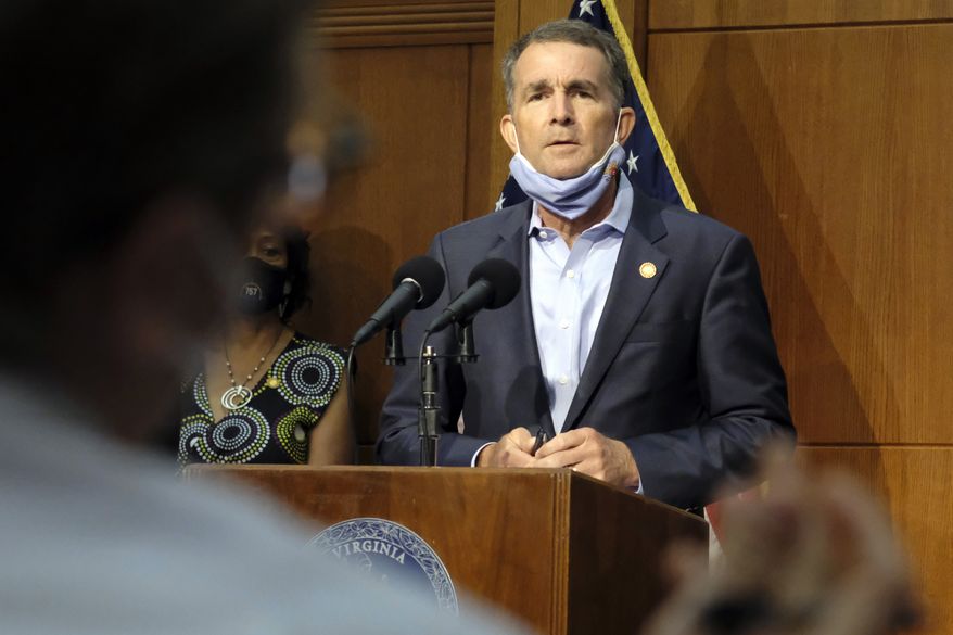 In this Sept. 1, 2020, photo, Virginia Gov. Ralph Northam listens to a reporter's question during a press briefing inside the Patrick Henry Building in Richmond, Va. Northam and his wife have both tested positive for the coronavirus. The governor’s office said in a statement Friday, Sept. 25, that Northam no symptoms while those of Pam Northam are mild. (Bob Brown/Richmond Times-Dispatch via AP) **FILE**