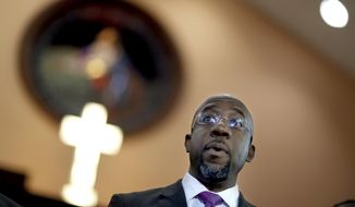 FILE -  In this Jan. 12, 2018 file photo Rev. Raphael Warnock speaks at Ebenezer Baptist Church in Atlanta.  Former President Barack Obama is endorsing Warnock in the race to fill a U.S. Senate seat in Georgia. Warnock is one of the Democrats running in a crowded field for the special election to be held Nov. 3, 2020. The seat is currently held by Republican Kelly Loeffler, a wealthy businesswoman who was appointed earlier this year by Republican Gov. Brian Kemp.  (AP Photo/David Goldman, File)