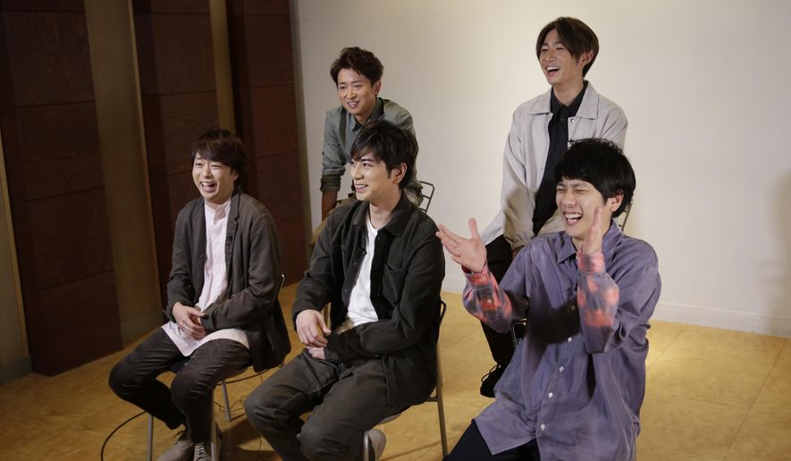 Members of Japanese pop music band ARASHI listen to a question during an interview with The Associated Press in Tokyo on Thursday, Sept. 17, 2020. Back row, from left, clockwise, are Satoshi Ohno, Masaki Aiba, Kazunari Ninomiya, Jun Matsumoto and Sho Sakurai. Japanese pop sensation Arashi has a big surprise for fans as they near their planned hiatus at year's end: a collaboration with Bruno Mars on their first all-English single. (AP Photo/Hiro Komae)