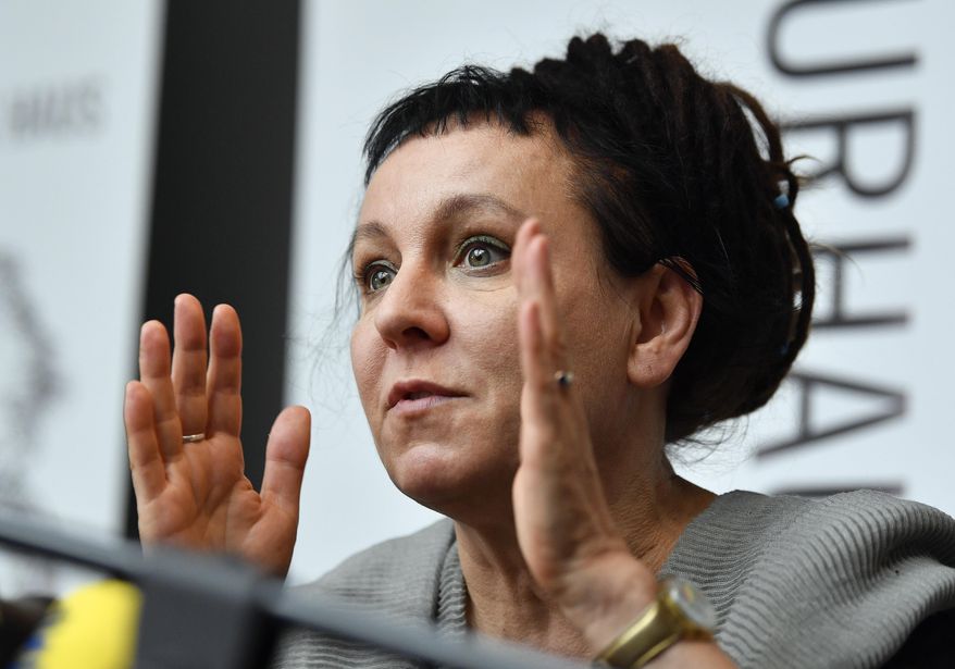 FILE - In this Friday, Oct. 11, 2019 file photo, Polish writer and Nobel Prize winner Olga Tokarczuk reacts to the media during a press conference in Duesseldorf, Germany. Nobel Prize-winning writer Olga Tokarczuk has declined an honorary citizenship from the region of Poland where she lives because she would have had to share the honor with a Roman Catholic bishop who has made hostile comments about the LGBT community. Tokarczuk said in a tweet Friday, Sept. 25 that while she appreciated being considered, she “sadly” couldn’t accept Lower Silesia’s honorary citizenship. (AP Photo/Martin Meissner, file)