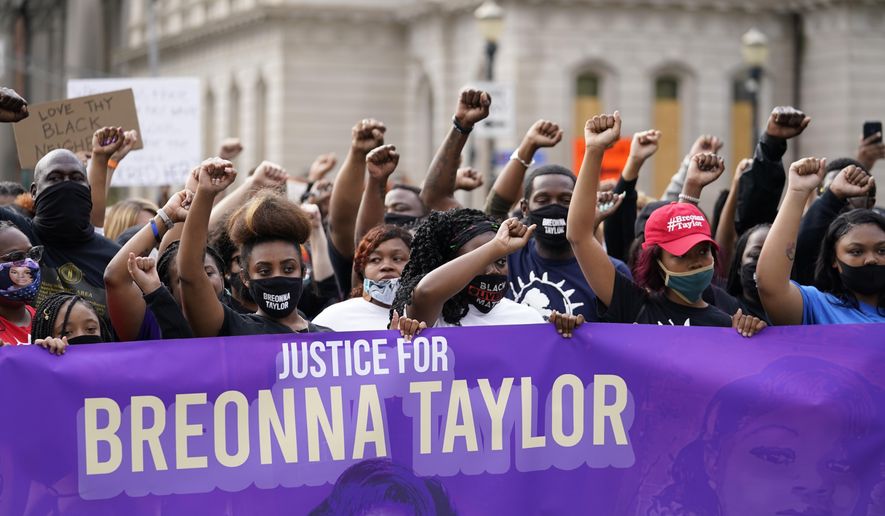 Black Lives Matter protesters march, Friday, Sept. 25, 2020, in Louisville. Breonna Taylor's family demanded Friday that Kentucky authorities release all body camera footage, police files and the transcripts of the grand jury hearings that led to no charges against police officers who killed the Black woman during a March drug raid at her apartment. (AP Photo/Darron Cummings)