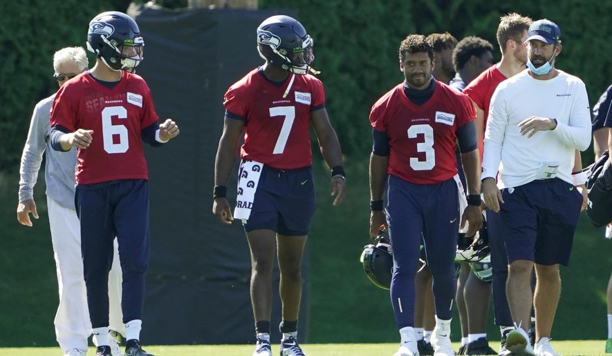 Seattle Seahawks quarterbacks Russell Wilson (3), Geno Smith (7) and Anthony Gordon (6) walk with offensive coordinator Brian Schottenheimer, right, and head coach Pete Carroll, left, following the last day of NFL football training camp, Thursday, Sept. 3, 2020, in Renton, Wash. (AP Photo/Ted S. Warren)
