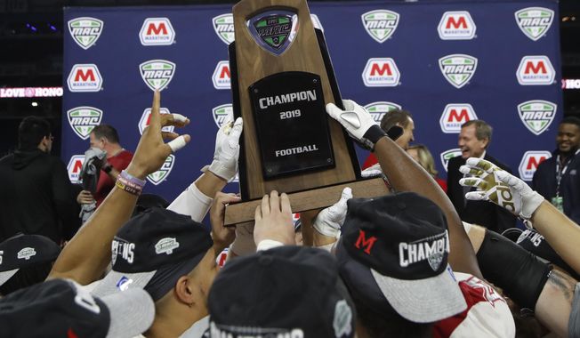 d FILE - In this Dec. 7, 2019, file photo, members of the Miami of Ohio team hold the champion trophy after the Mid-American Conference championship NCAA college football game against Central Michigan in Detroit. The Mid-American Conference announced Friday, Sept. 25, 2020, that it will have a 6-game football season, meaning all 10 major conferences will play this fall. (AP Photo/Carlos Osorio, File)