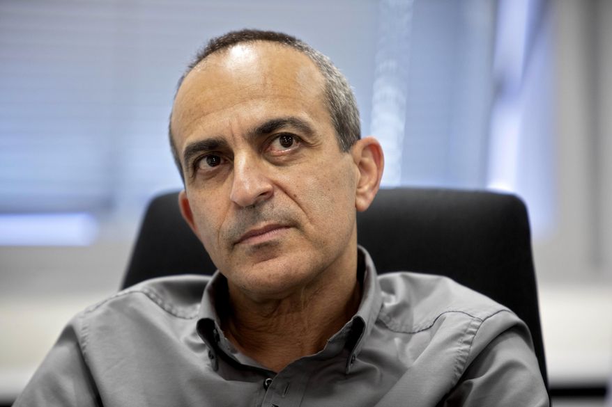Israeli Dr. Ronni Gamzu speaks during an interview with the Associated Press at his office near the central Israeli city of Lod, Thursday, Sept. 24, 2020. Gamzu is a cancer survivor. It was that personal battle that readied him for his greatest professional challenge: steering Israel's troubled coronavirus response. (AP Photo/Sebastian Scheiner)