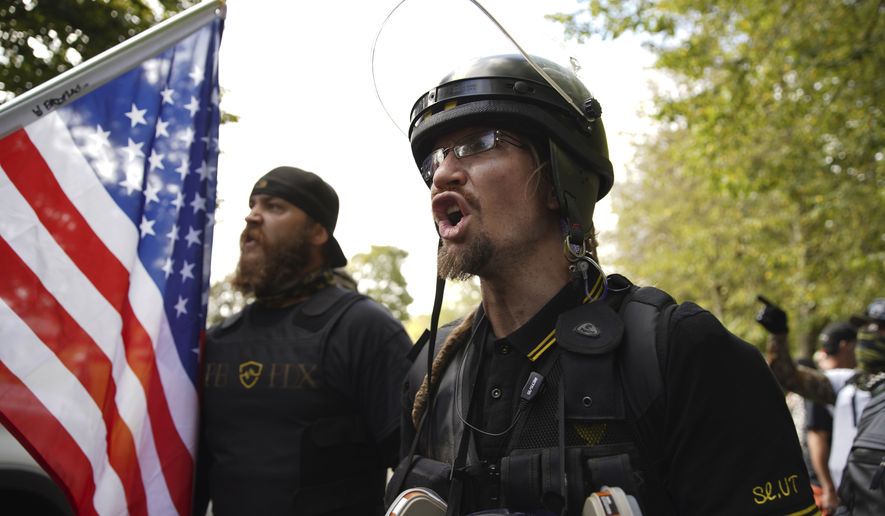 Members of the Proud Boys and other right-wing demonstrators rally on Saturday, Sept. 26, 2020, in Portland, Ore. (AP Photo/Allison Dinner)