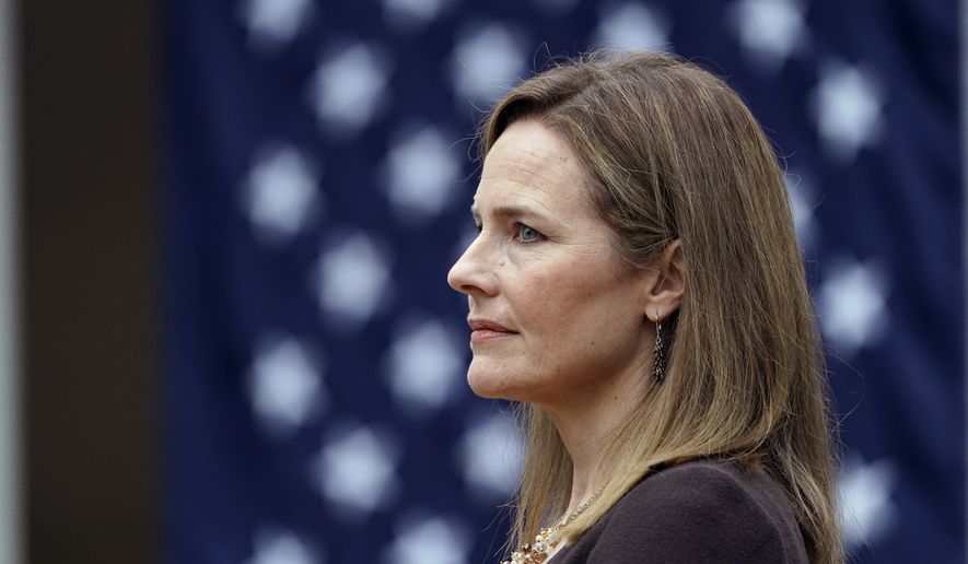 Judge Amy Coney Barrett listens as President Donald Trump announces Barrett as his nominee to the Supreme Court, in the Rose Garden at the White House, Saturday, Sept. 26, 2020, in Washington. (AP Photo/Alex Brandon)