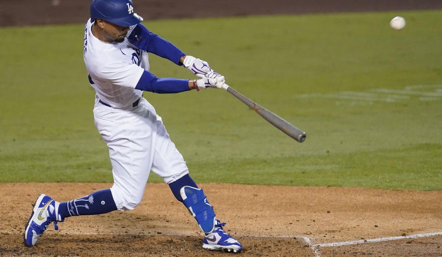 Los Angeles Dodgers' Mookie Betts flies out to right field during the third inning of the team's baseball game against the Los Angeles Angels on Friday, Sept. 25, 2020, in Los Angeles. (AP Photo/Ashley Landis)